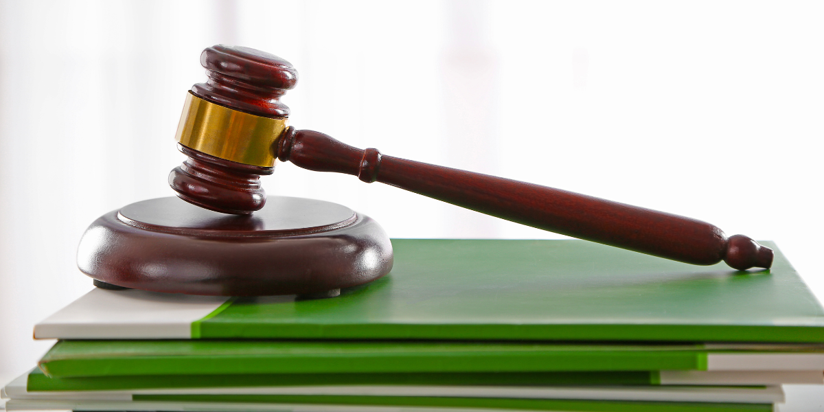 Judge’s gavel resting on green legal books, symbolizing LTC payroll tax legislation