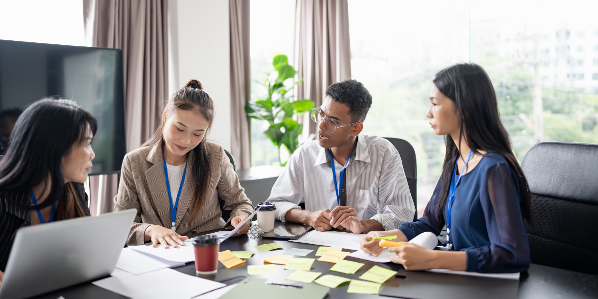 Employees attending a workplace benefits meeting, learning about Life with Long-Term Care Hybrid insurance options.
